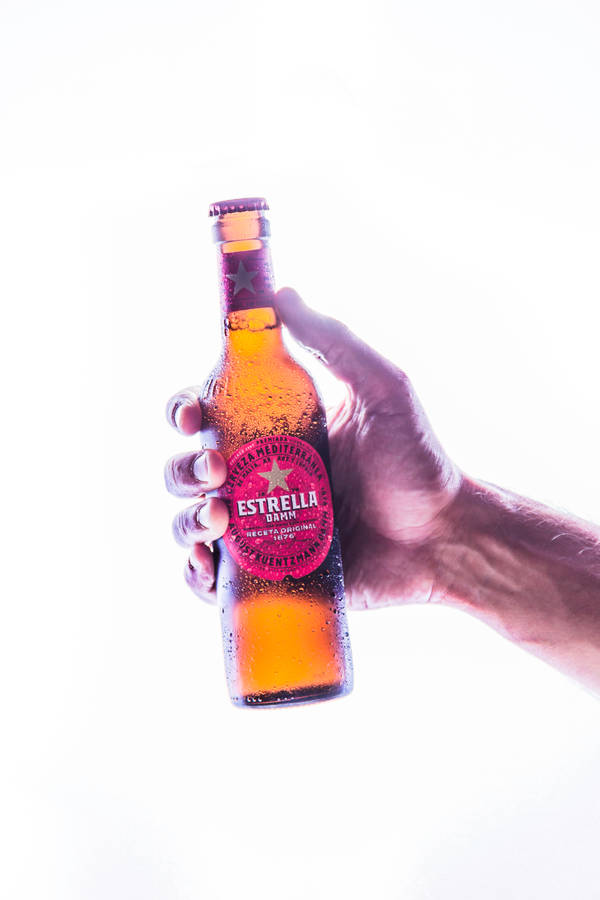 Estrella Damm In Hand Wallpaper