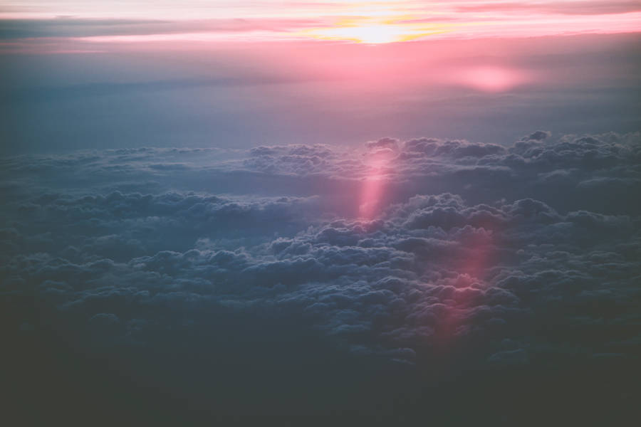 Ethereal Pink Sunset Amidst High Resolution Clouds Wallpaper