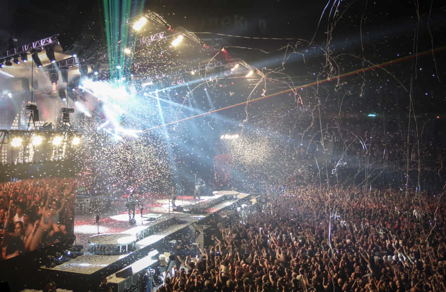 Excited Crowd Enjoying Live Performances At Music Festival Wallpaper