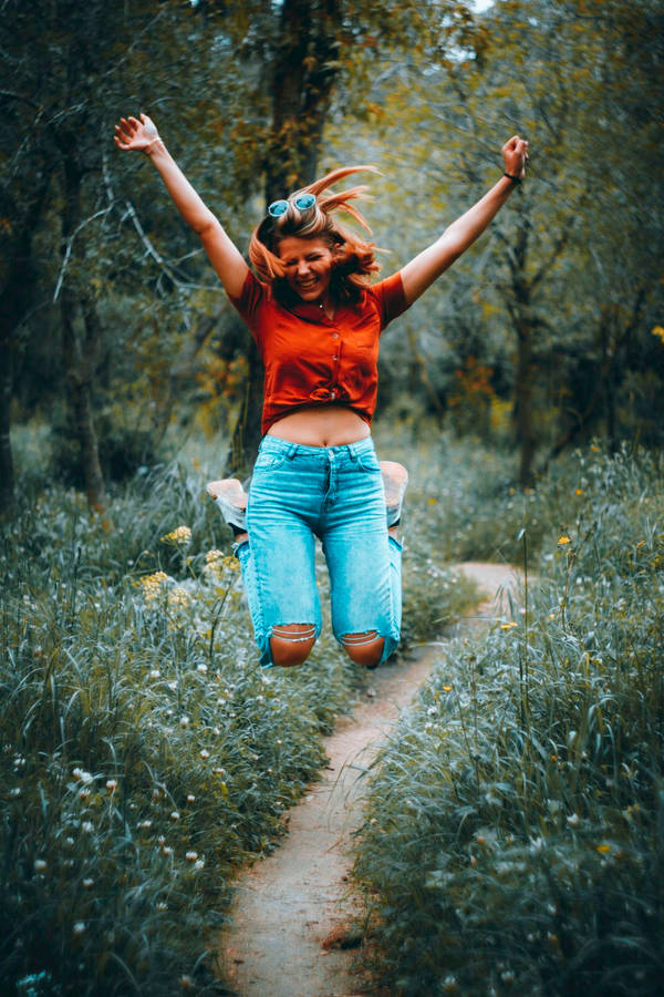 Excited Girl In A Forest Pathway Wallpaper