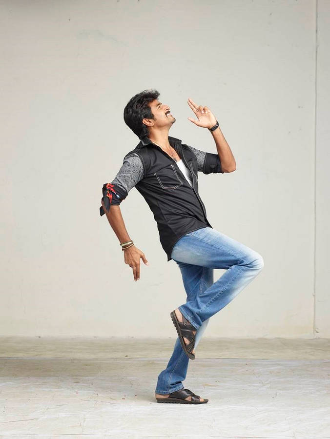 Exciting Action Shot Of Sivakarthikeyan Running Wallpaper