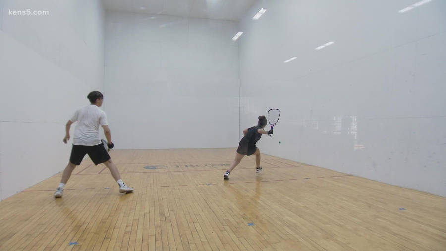 Exciting Moment Of Powerful Return In A 1v1 Racquetball Match. Wallpaper