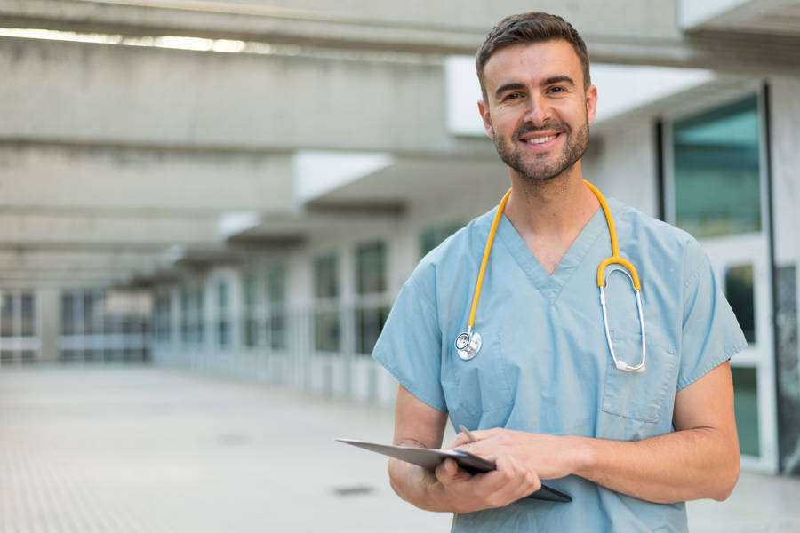 Experienced Male Nurse In Medical Uniform Wallpaper