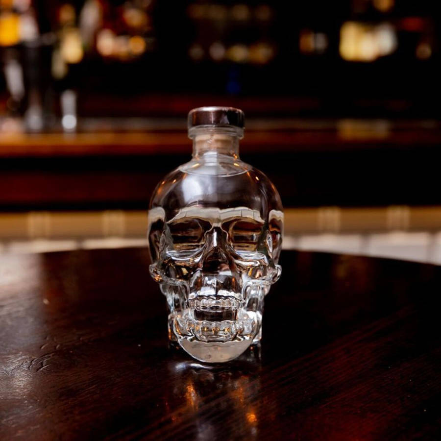 Exquisite Crystal Head Vodka Bottle On An Oak Table Wallpaper