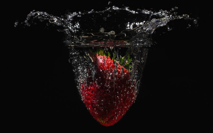 Falling Strawberry In Water Wallpaper
