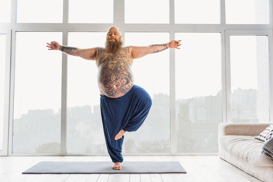 Fat Man In Yoga Stance Wallpaper