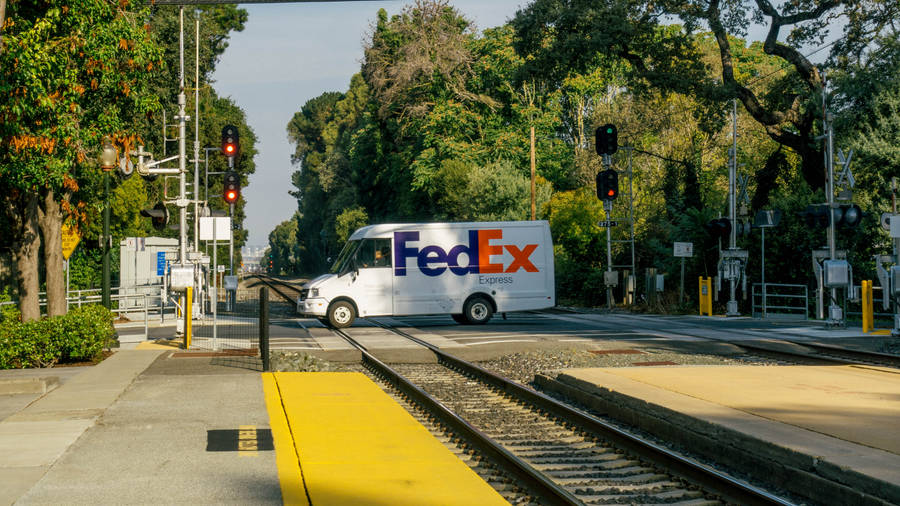 Fedex Van At Railway Crossing Wallpaper