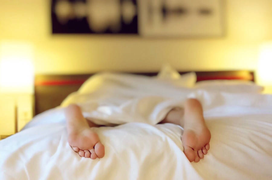 Feet On A White Bed Wallpaper