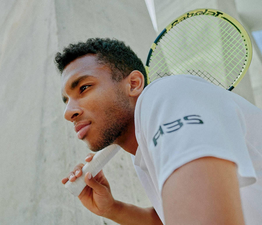 Felix Auger-aliassime In Action On The Tennis Court Wallpaper