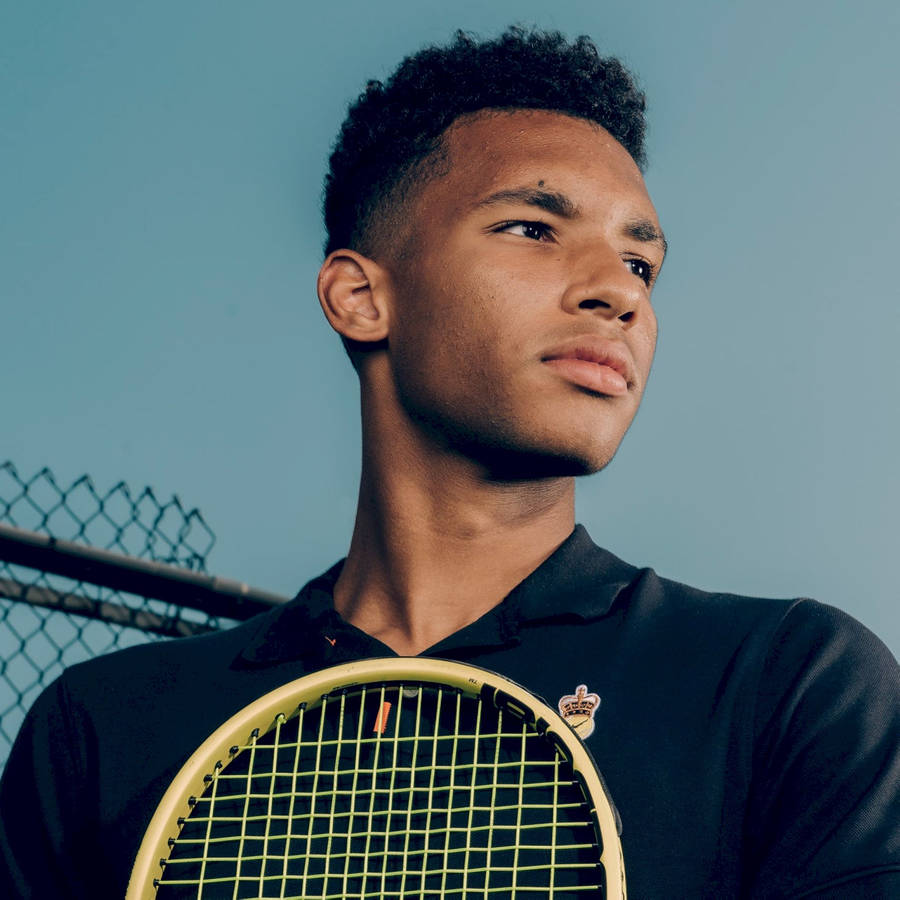 Felix Auger-aliassime In Thoughtful Contemplation Wallpaper