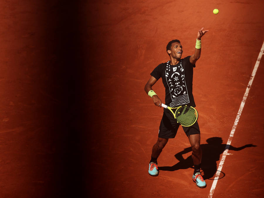 Felix Auger Aliassime Throwing Ball To Serve Wallpaper