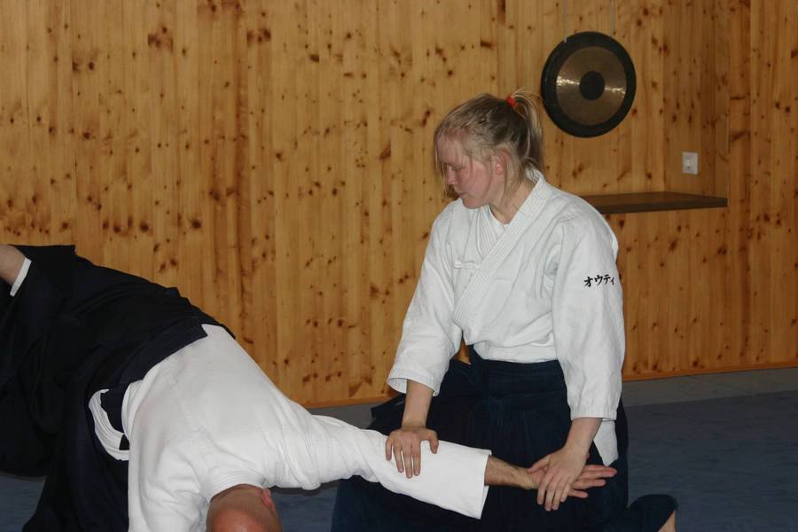 Female Aikidoka Executing Koshi Nage Technique Wallpaper