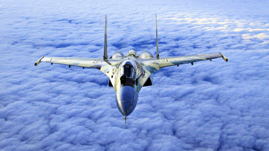 Fighter Jet Over A Cloud Cover Wallpaper