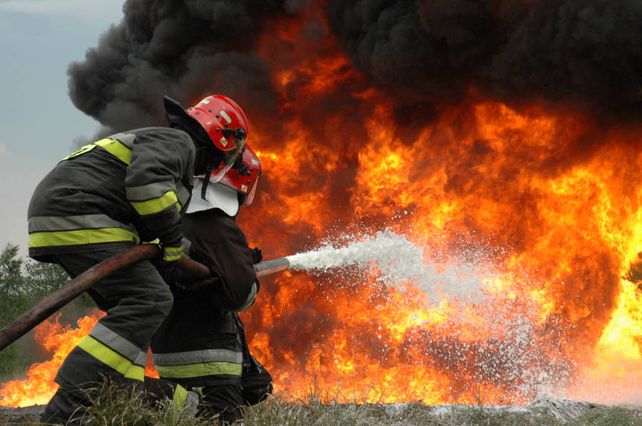 Fireman Fighting A Huge Fire Wallpaper