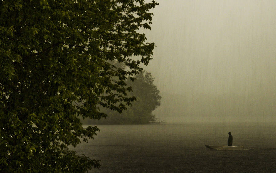 Fisherman During A Beautiful Rain Downpour Wallpaper