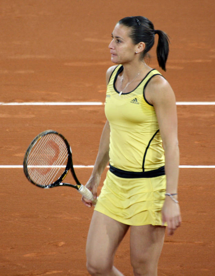 Flavia Pennetta Striking A Pose In Her Stylish Yellow Tennis Outfit. Wallpaper