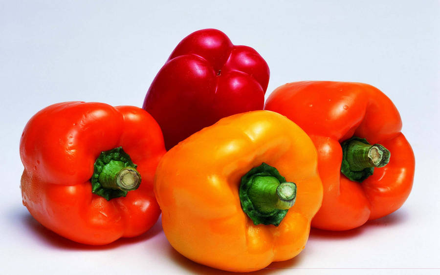 Four Fresh Bell Pepper Fruits Still Wallpaper