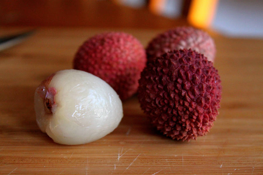 Four Litchis On Cutting Board Wallpaper