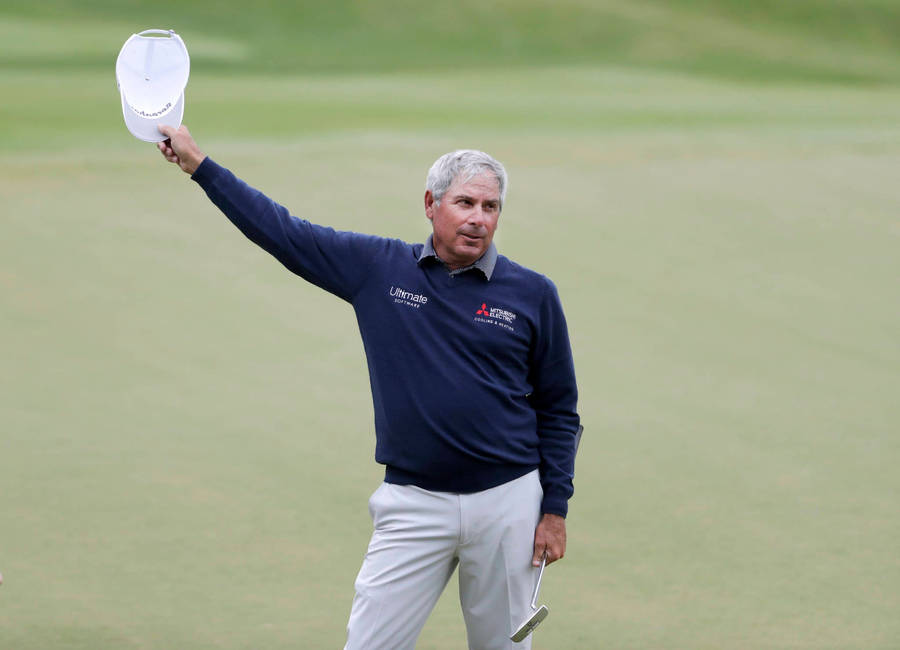 Fred Couples Swinging With Style In A White Cap Wallpaper