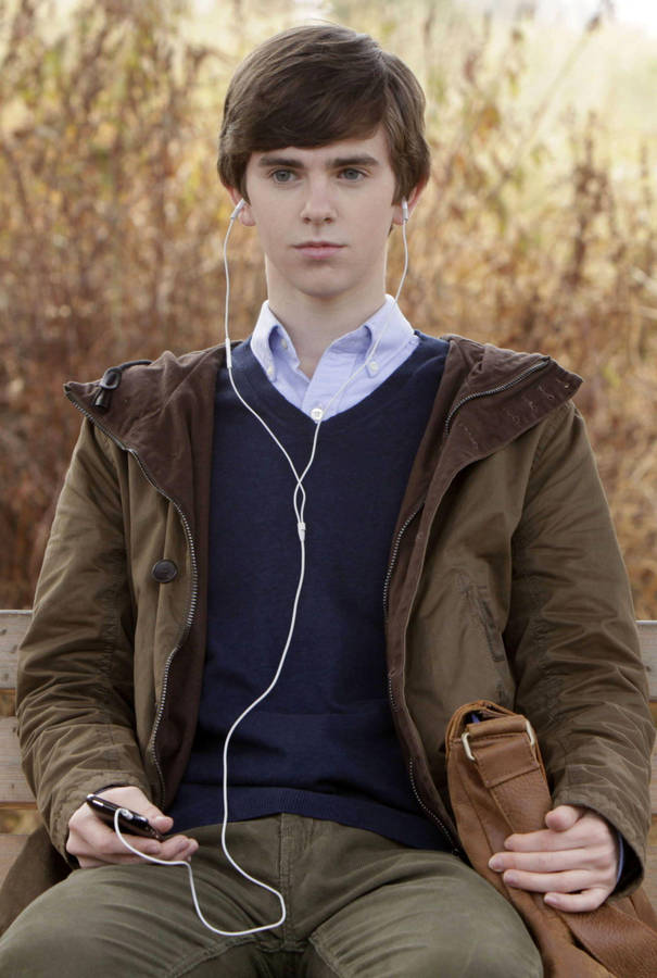 Freddie Highmore Listening With Earphones Wallpaper