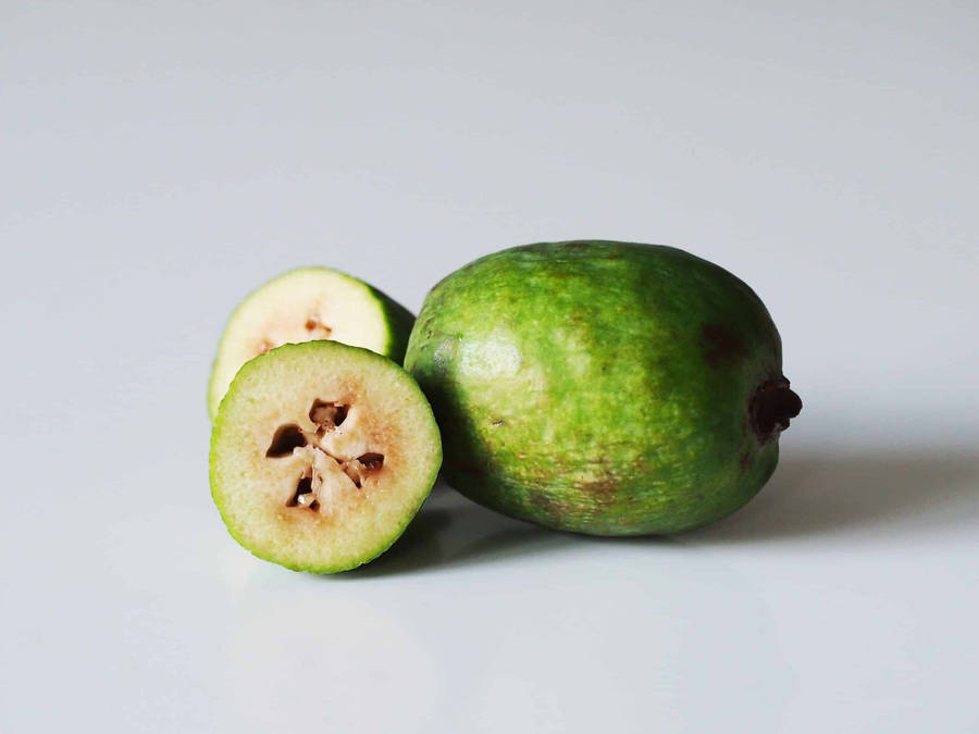 Fresh And Delicious Feijoas - Whole And Halved Wallpaper