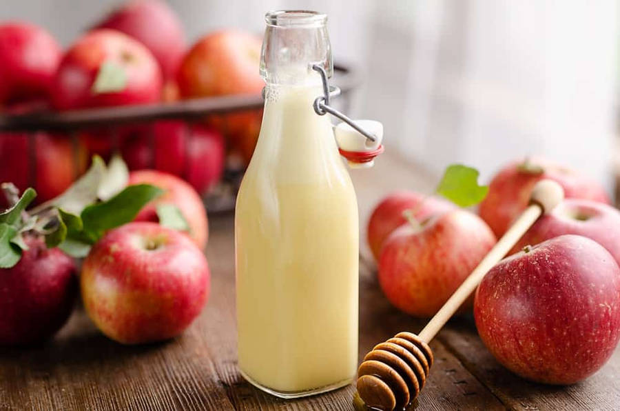 Fresh Apple Cider Vinegar In A Glass Bottle Wallpaper