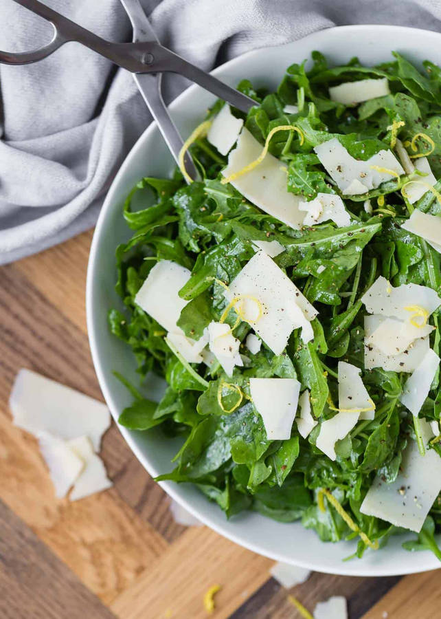 Fresh Arugula And Parmesan Cheese Salad Wallpaper