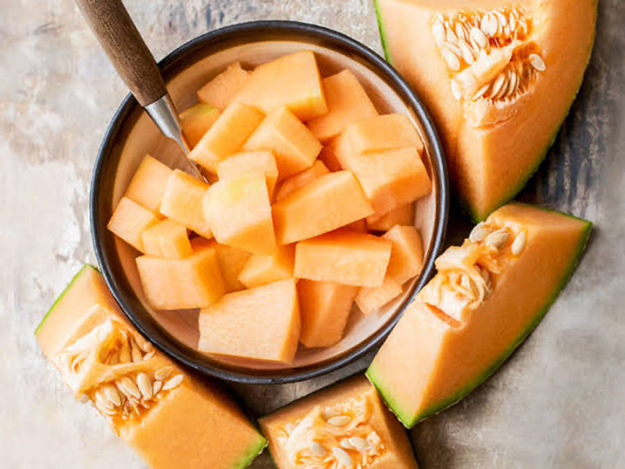 Fresh Cantaloupe In A Ceramic Bowl Wallpaper