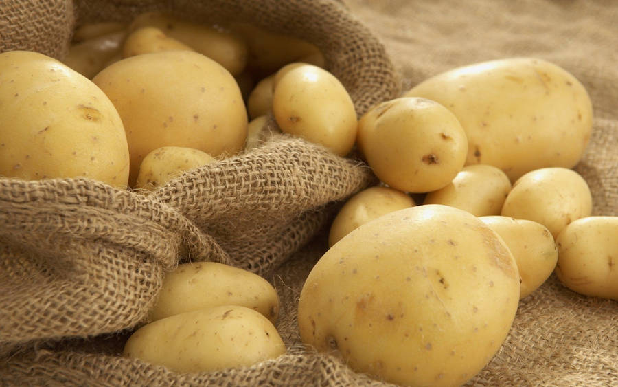 Fresh Harvested Potatoes On Burlap Sack Wallpaper