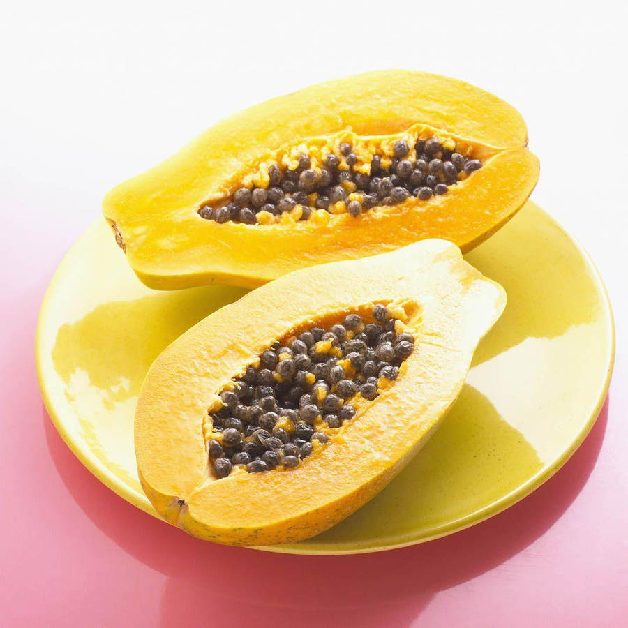 Fresh Papaya Fruit On Yellow Plate Wallpaper