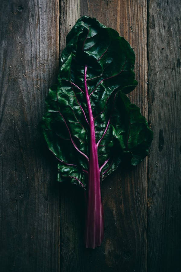 Fresh Swiss Chard On Rustic Wooden Table Wallpaper