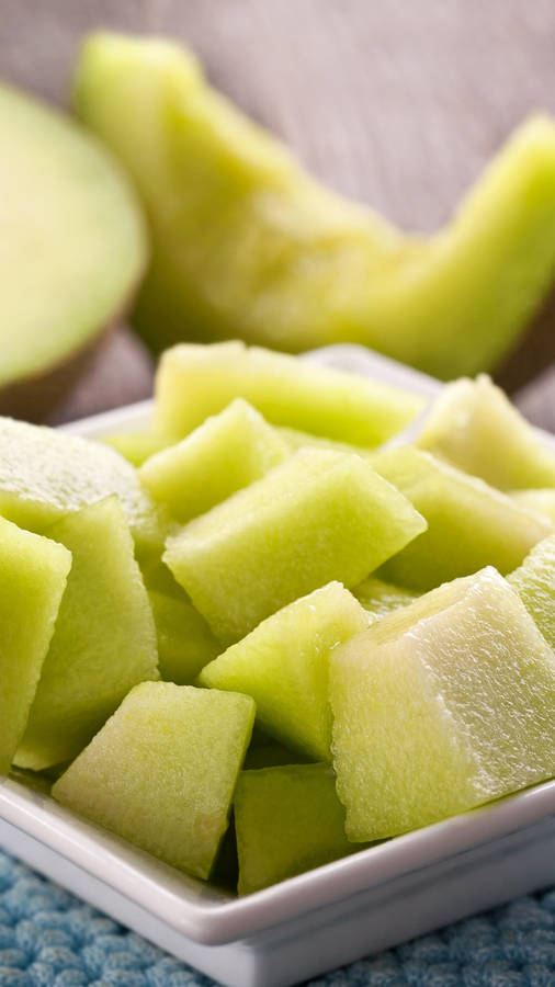 Freshly Sliced Honeydew Melon Served On A Plate Wallpaper