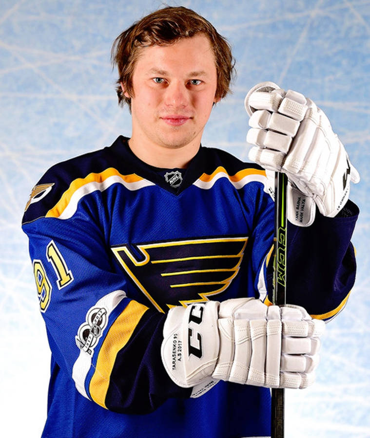 Front Portrait Of Vladimir Tarasenko Smirking While Holding Hockey Stick Wallpaper