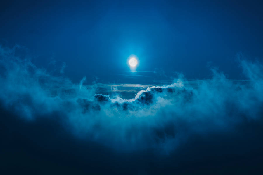 Full Moon Among Dark Blue Clouds Wallpaper