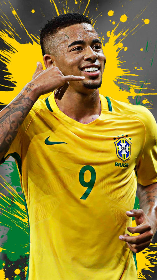 Gabriel Jesus In Yellow Phone Gesture Wallpaper