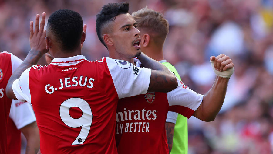 Gabriel Martinelli Hugged By Teammate Wallpaper