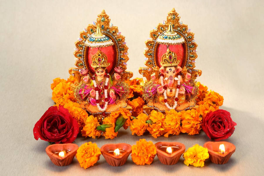 Ganesh And Lakshmi With Garlands Wallpaper