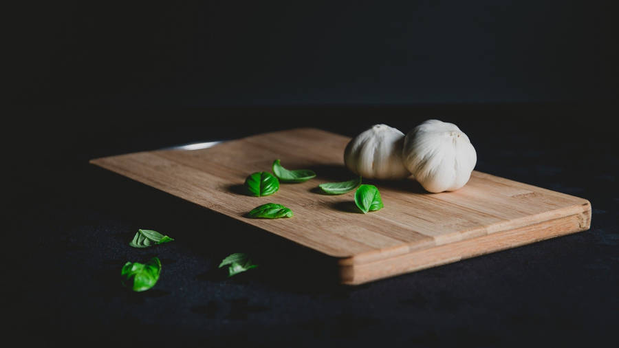 Garlic Vegetable Herb With Leaves On Chopping Board Wallpaper