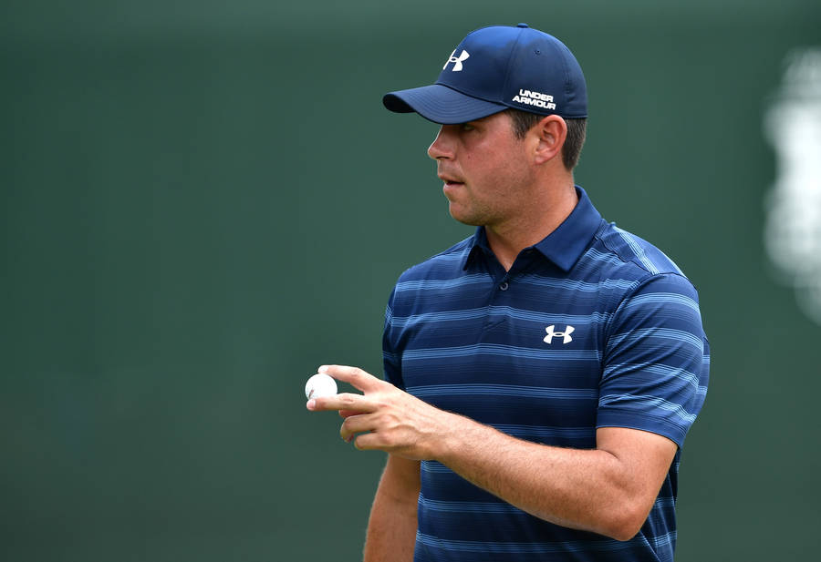 Gary Woodland Proudly Holding A Golf Ball During A Tournament Wallpaper