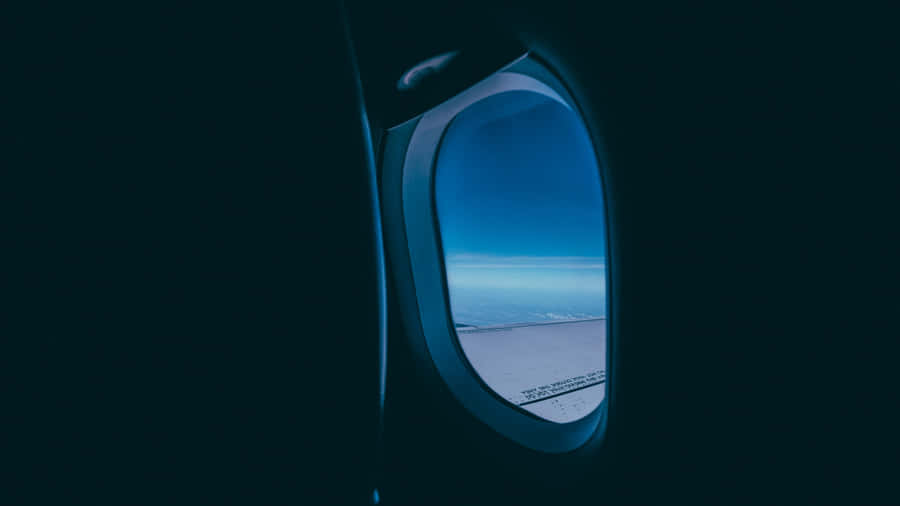 Gazing At The Blue Sky Through An Airplane Window Wallpaper