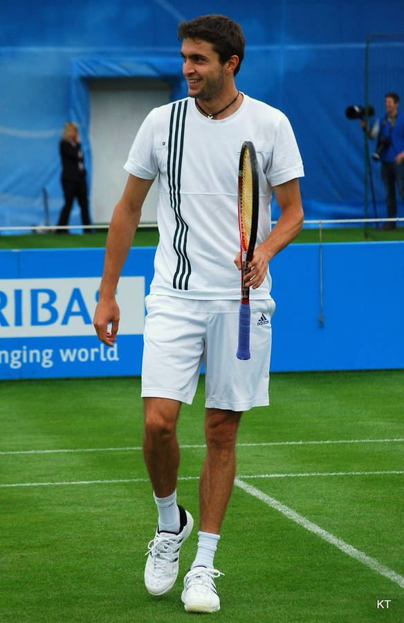 Gilles Simon In Action With His Signature Racket Wallpaper