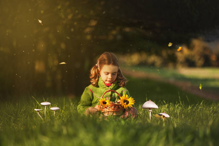 Girl Child Holding Sunflowers In Spring Wallpaper