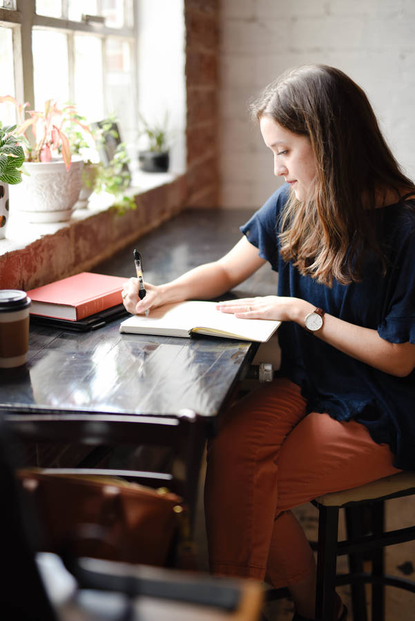 Girl Reading Book In Window Wallpaper