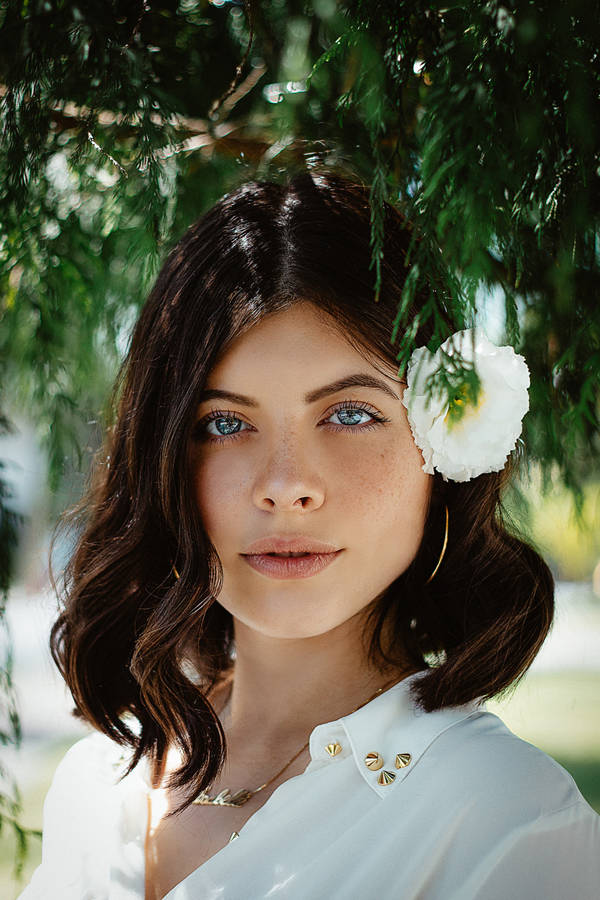 Girl With Flower On Her Ear Headshot Wallpaper