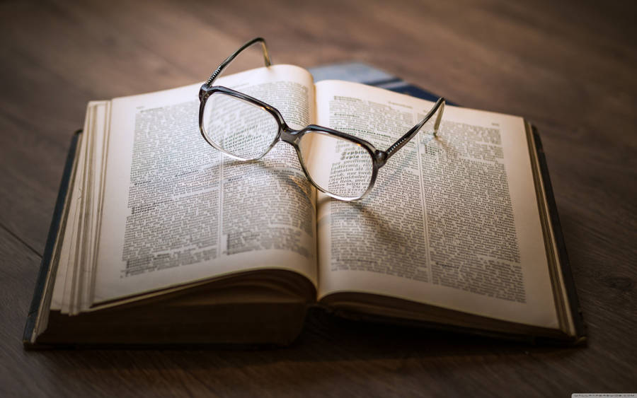 Glasses On Open Book Wallpaper