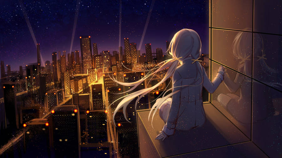 Gleaming Buildings And Illuminated Public Art Form A Mesmerizing Cityscape Against The Night Sky. Wallpaper