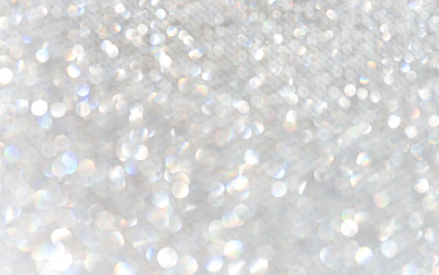 Gold And Silver Glitter Against A White Background Wallpaper