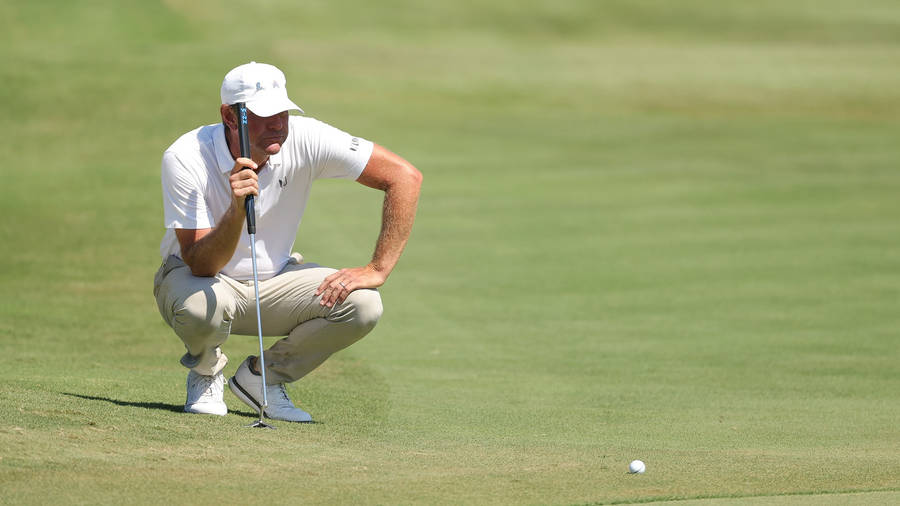 Golfer Lucas Glover Reflective On The Golf Course Wallpaper