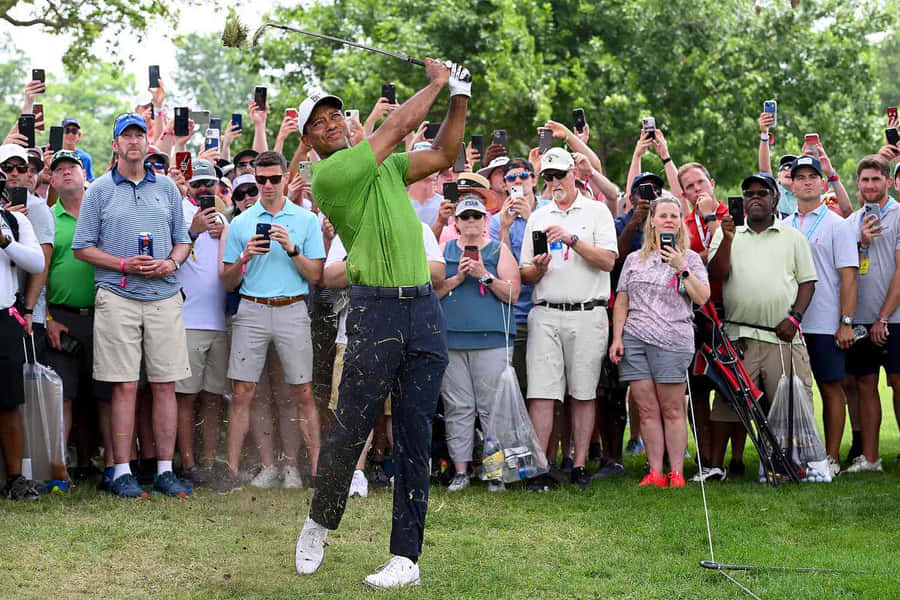 Golfer Swinging Club Crowd Watching Wallpaper