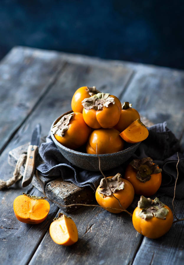 Gorgeous Bowl Of Persimmon Fruit Wallpaper